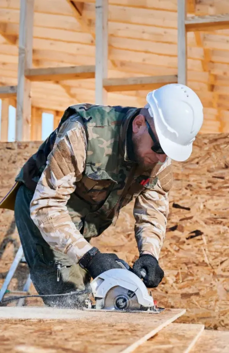 ADU construction worker cutting wood framing during backyard ADU build in Los Angeles