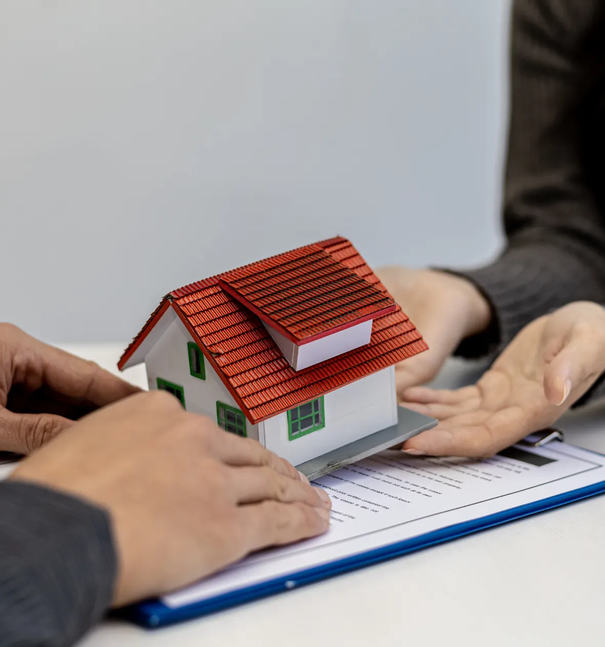 ADU permits and city approval in Los Angeles CA homeowner reviewing contract with house model during approval process