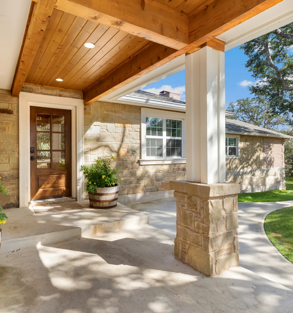 Attached ADU construction in Los Angeles CA home extension with covered entry porch and stone exterior details