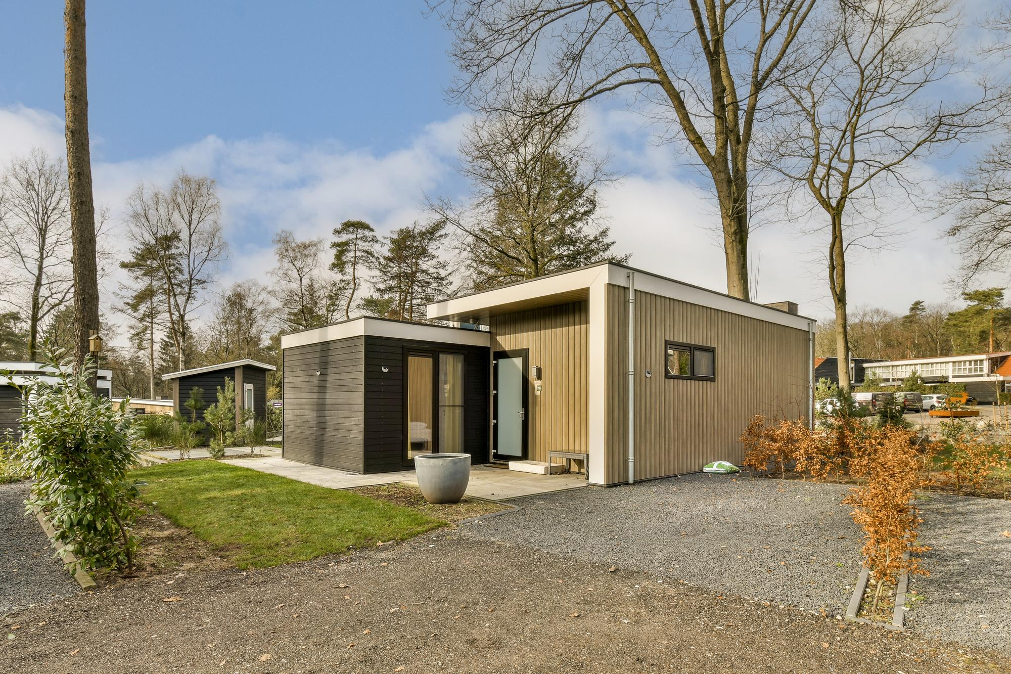 Luxury modern ADU home exterior with balcony and glass walls – Best ADU LA